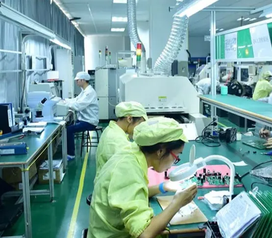 jarnistech-pcb-inspection Jarnistech technicians inspecting assembled circuit boards on a factory production line.